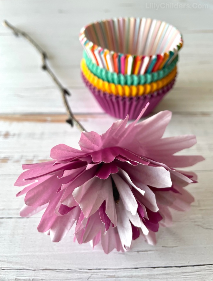 Cupcake Liner Flowers | This easy DIY craft turned out absolutely beautiful! I made a bouquet with the flowers that actually turned out to make for lovely home decor on my entry table. You could also use these DIY paper flowers with stems as a party decoration. Baby showers, bridal showers, birthdays, etc! These would make for a great gift idea, too. An easy and affordable craft idea for adults to make at home!