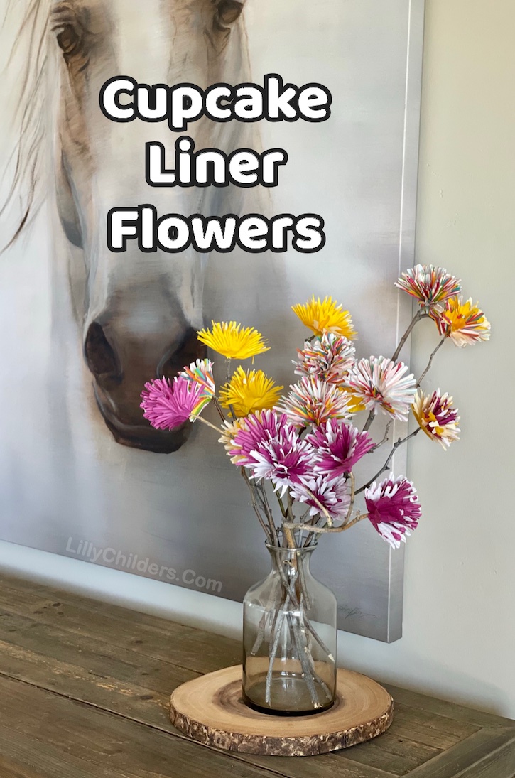 These cupcake liner flowers are an inexpensive and easy craft to make! I think this beautiful project is ideal for adults and teenagers, but older kids could definitely manage it because these paper flowers are actually really simple to make with a hot glue gun and a few other cheap supplies including sticks from your yard! We decided to display them on our entry table as part of our home decor, but how about a centerpiece for a party! They would be wonderful for any occasion. 