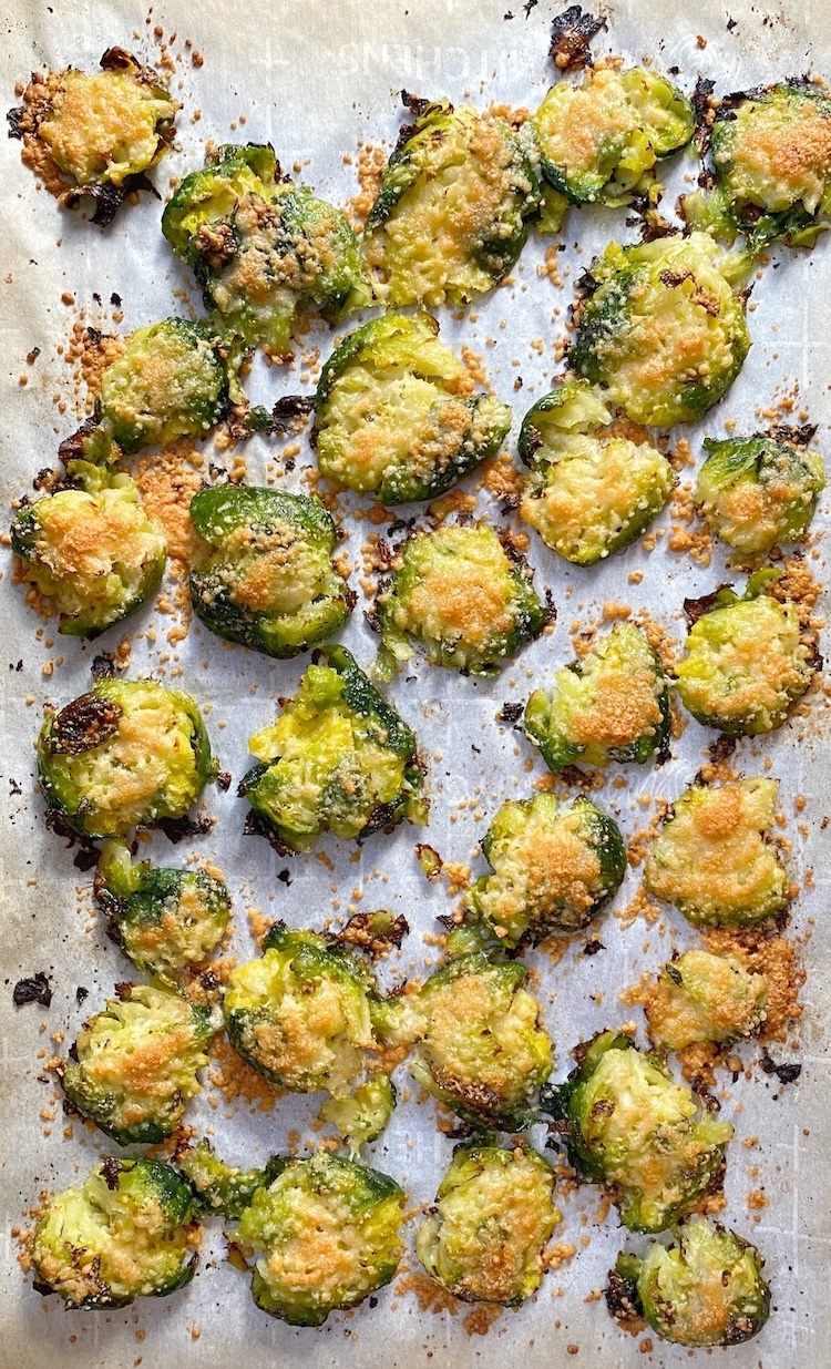 How to make yummy and crispy brussels sprouts in the oven! Simply steam them, season them, smash them, top with parmesan cheese, and then roast. 