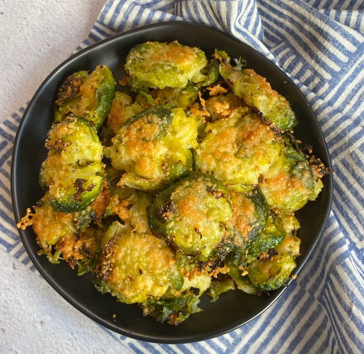 Smashed Crispy Brussels Sprouts on a plate ready to be eaten for dinner as the best veggie side dish!