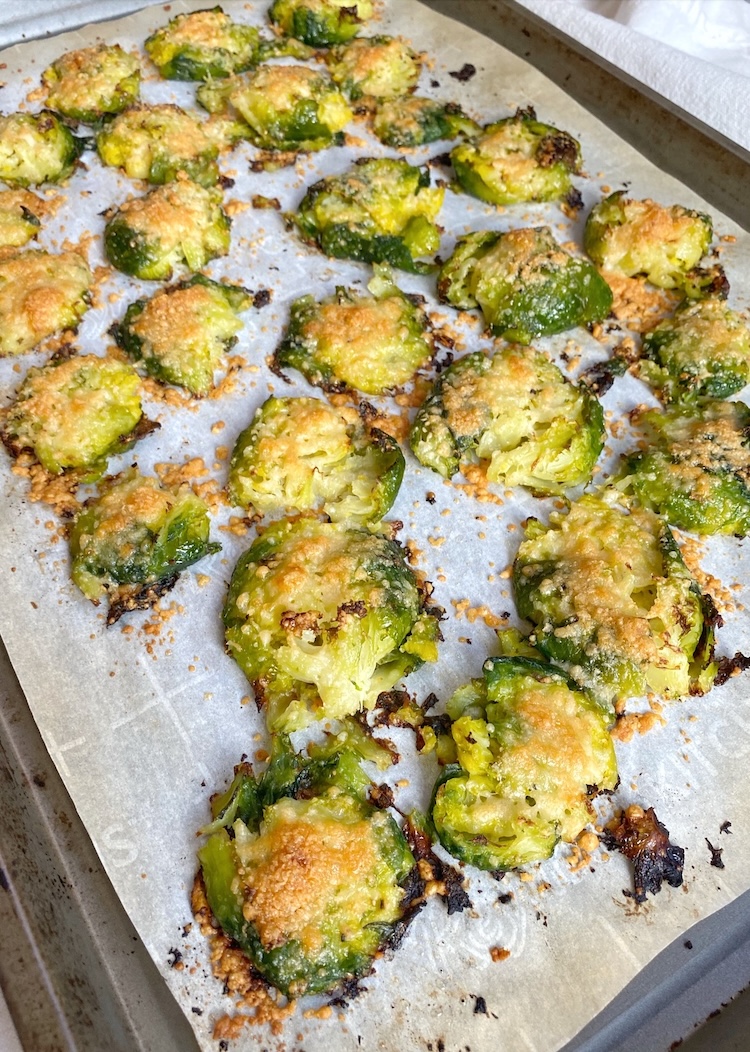 Smashed brussels sprouts after being roasted with parmesan cheese in the oven. The best way to make them crispy and yummy!