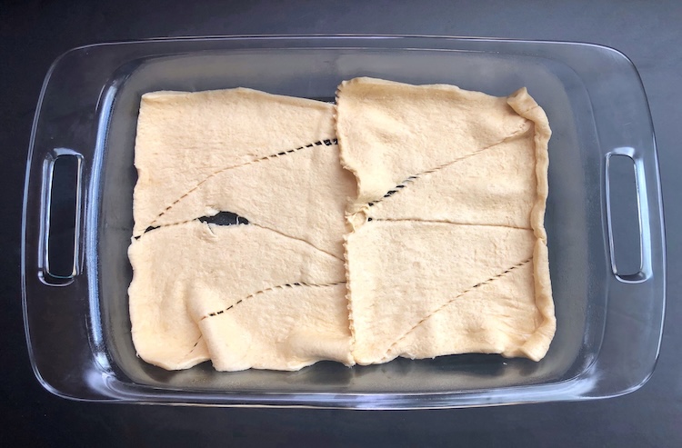 Place the Pillsbury Crescent Dough onto the bottom of a greased baking dish and use your fingers to press the seams together. This creates the delicious, buttery, flaky crust. 