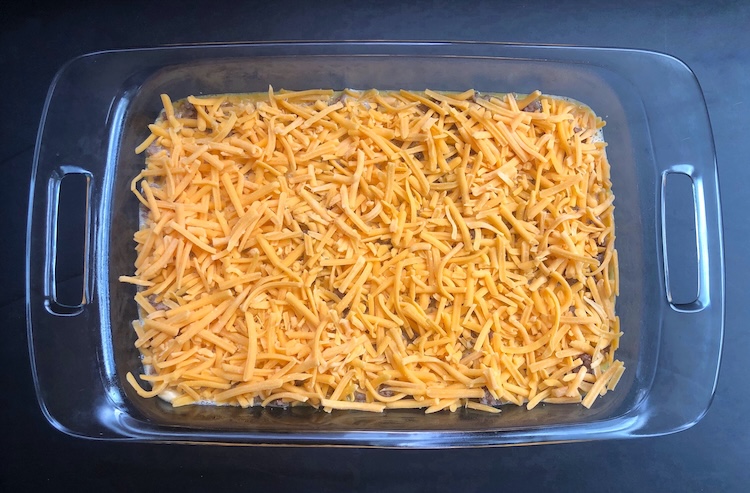 For the final step, evenly sprinkle on lots of shredded cheddar cheese. 