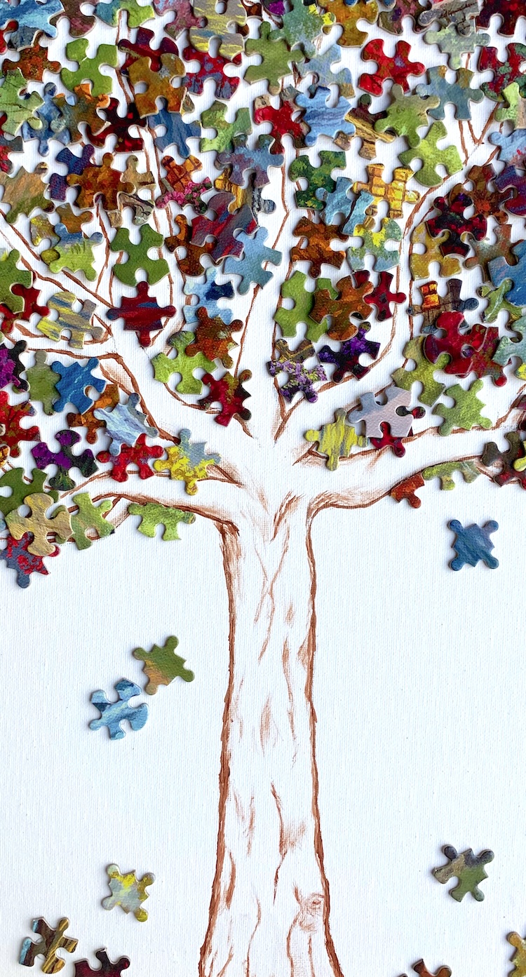 DIY Canvas Art Idea using puzzle pieces! A great way to recycle an old puzzle that is missing pieces-- make colorful and creative art! I made a leafy tree covering a hand painted tree trunk.