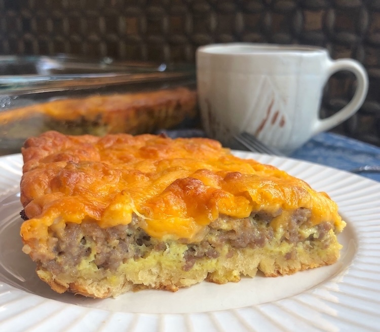 How to make the best cheesy sausage and egg breakfast casserole with a tube of Pillsbury Crescent Rolls! This easy breakfast is fun to make in a large baking dish by simply layering the ingredients and then baking until hot and gooey. 
