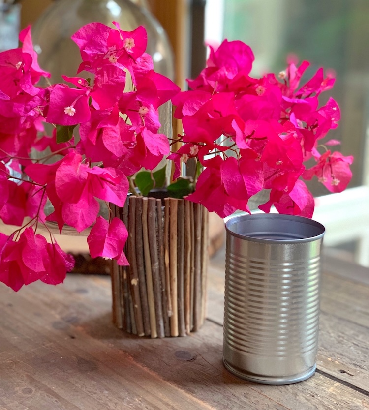 Tin can covered in sticks to make a whimsical and rustic vase. 