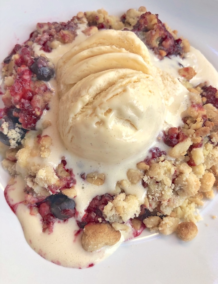 Easy frozen berry and cake mix cobbler dessert recipe topped with vanilla ice cream. 