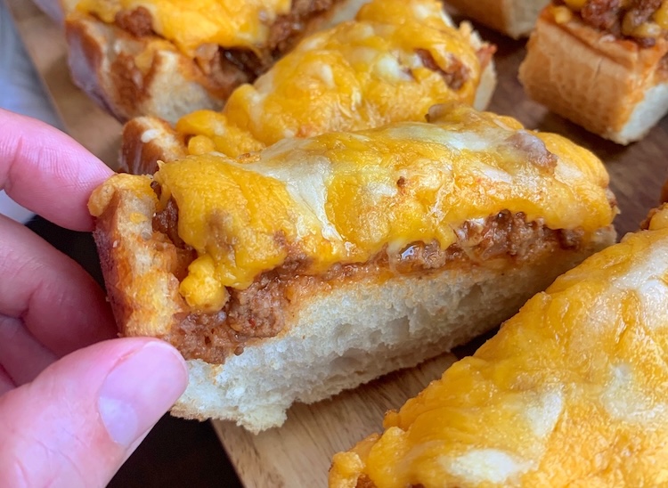 Sloppy Joe French Bread Pizza Slices | A fun handheld food idea for dinner and parties! The ultimate cheesy comfort food.