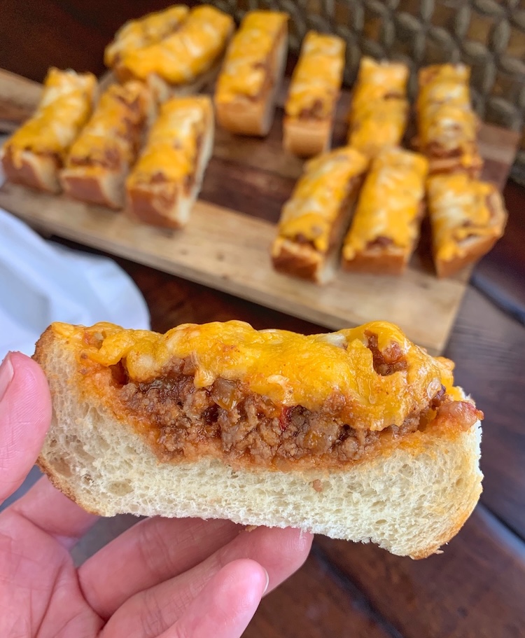 If you're looking for fun ground beef dinner ideas, try this easy Sloppy Joe Pizza made with French bread! It's cheesy finger food that's perfect for quick meals as well as simple party food.