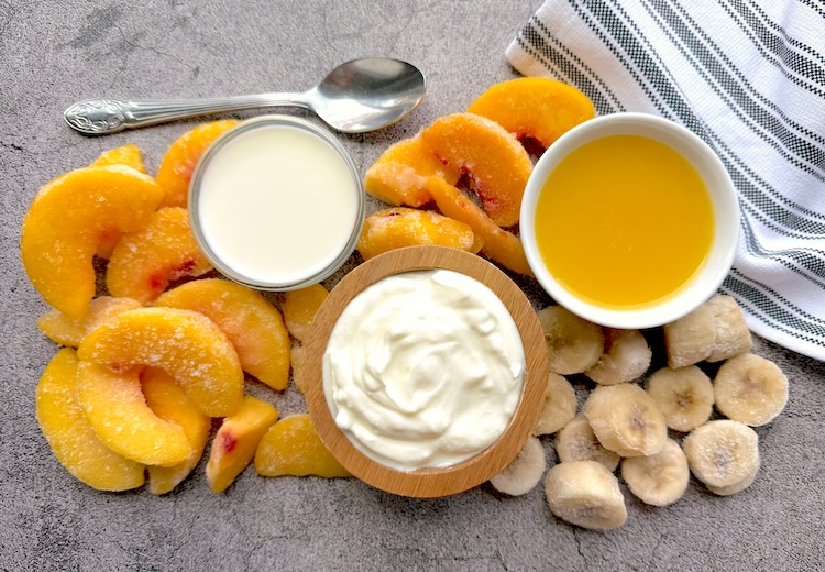 Ingredients for making a healthy peach smoothie for summer. 